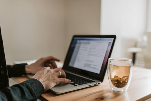 man on his laptop with tea