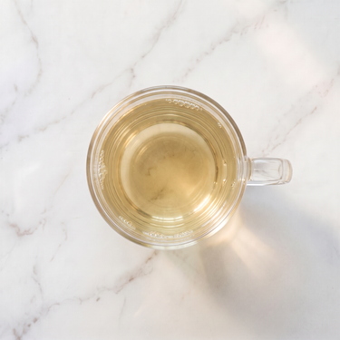 100 Monkeys Chinese White Tea brewed infusion in a glass cup