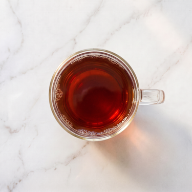 Bourbon Vanilla Rooibos Tea brewed infusion in a glass cup