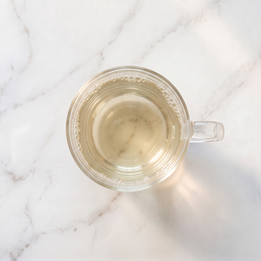 Pai Mu Tan White Tea brewed infusion in a glass cup
