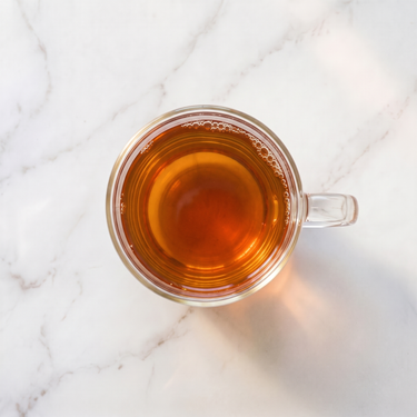 Assam Gingia Black Tea brewed infusion in a glass cup