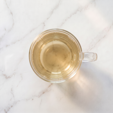 Snow Dragon White Tea brewed infusion in a glass cup