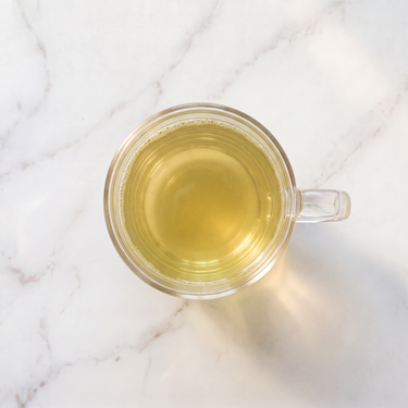 Voyage en Toscane Green Tea brewed infusion in a glass cup