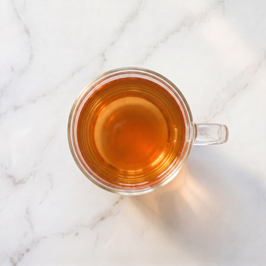 Wuyi Rock Oolong Tea brewed infusion in a glass cup