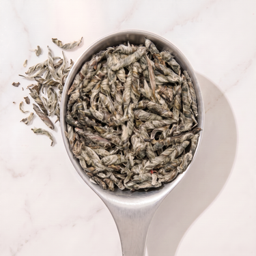 Snow Dragon White Tea in a measuring scoop