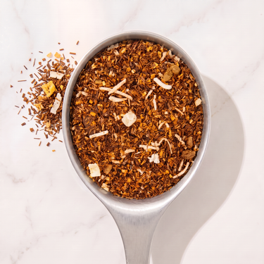Tropical Paradise Rooibos Tea in a measuring scoop