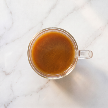 Cochin Masala Chai brewed infusion in a glass cup
