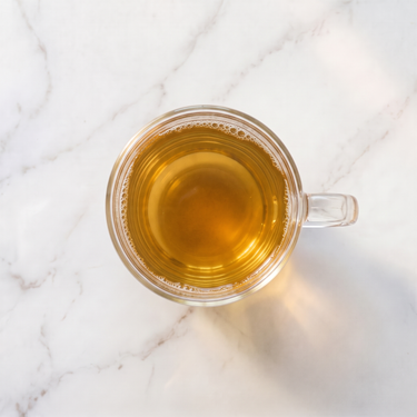 Hojicha Green Tea brewed infusion in a glass cup