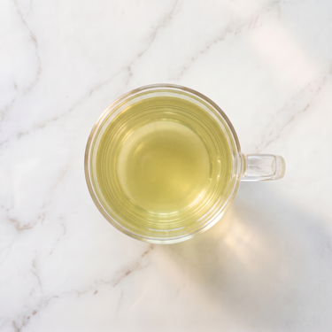 Sencha Decaf Green Tea brewed infusion in a glass cup