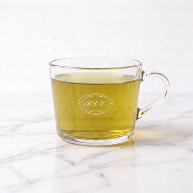 Petit Bonheur Strawberry Green Tea side view in a branded RDV glass cup