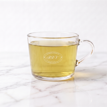 Snow Dragon White Tea side view in a branded RDV glass cup